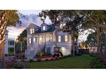 Stunning two-story home with inviting front porch, well-lit facade, and lush landscaping at dusk at 3307 Waterway Blvd, Isle of Palms, SC 29451