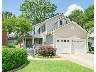 Charming two-story home featuring a manicured lawn and a two-car garage at 332 Clayton Dr, Charleston, SC 29414