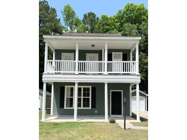 Charming two-story home with a classic design, complemented by a well-maintained lawn and surrounded by lush greenery at 4818 Buttercup Way, Summerville, SC 29485