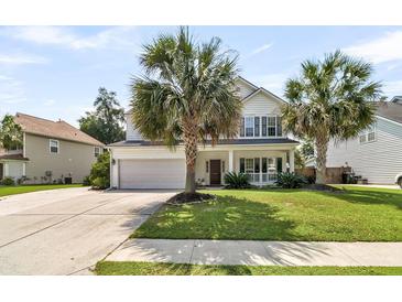 Charming two-story home with a manicured lawn and mature palm trees enhancing its curb appeal at 5257 Mulholland Dr, Summerville, SC 29485