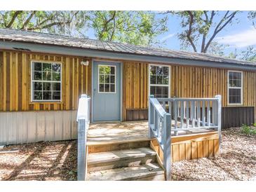 Charming home featuring wood siding, a metal roof, and a welcoming entryway with light blue trim at 5375 Highway 174, Adams Run, SC 29426