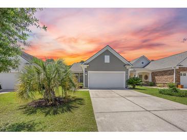 Charming home with a two-car garage, landscaped yard, and vibrant sunset view at 546 Sea Foam St, Summerville, SC 29486