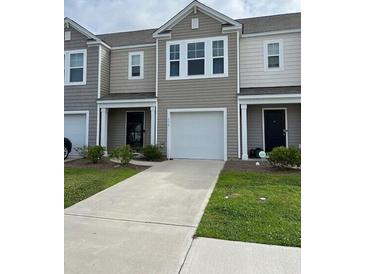 Charming two-story townhouse with a one car garage, well-maintained lawn, and neutral-toned exterior at 116 Gaura Ln, Summerville, SC 29483
