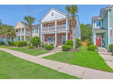 Charming two-story brick home boasts a double balcony, palm trees, and well-maintained landscaping at 2931 Waterleaf Rd, Johns Island, SC 29455
