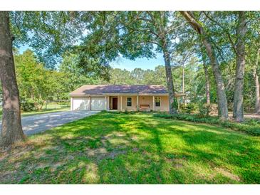 Charming single-story home featuring a spacious front yard and attached two car garage at 441 Compton Dr, Moncks Corner, SC 29461
