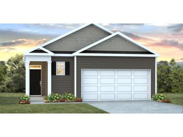 Charming single-story home featuring gray siding, white trim and a spacious two-car garage at 718 Long Bluff Rd, Summerville, SC 29486