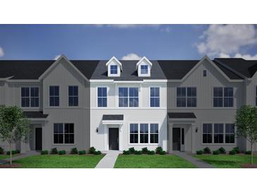 Charming new two-story townhouse with dormers, a well manicured lawn and neat landscaping at 127 Brown Swiss Cir, Summerville, SC 29483