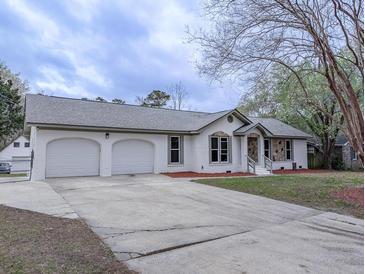 Charming single-story home with a two-car garage and a well-maintained front yard, showcasing curb appeal at 132 Tranquil Ln, Ladson, SC 29456
