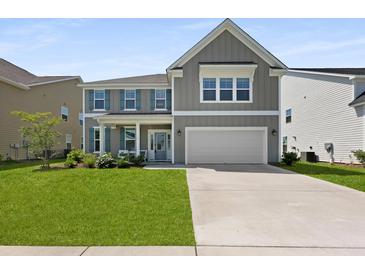 Charming two-story home with a manicured lawn, neutral siding, and inviting front porch at 133 Headwater Dr, Summerville, SC 29486