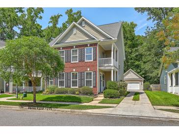 Charming two-story home featuring brick accents, a cozy porch, and a well-manicured lawn at 1408 Bimini Dr, Charleston, SC 29414