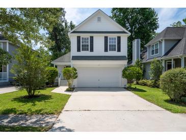 Charming two-story home with a two-car garage, landscaped yard, and inviting curb appeal at 1813 Parkland Preserve Ln, Charleston, SC 29412