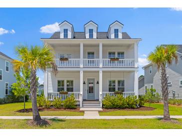 Charming two-story home with a double porch and lush landscaping at 1828 Agate Bay Dr, Mount Pleasant, SC 29466