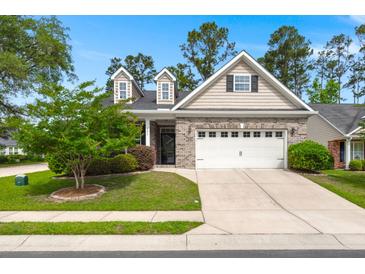 Charming home featuring a two-car garage, brick accents, and a well-maintained front yard at 207 Brutus Ln, Summerville, SC 29485