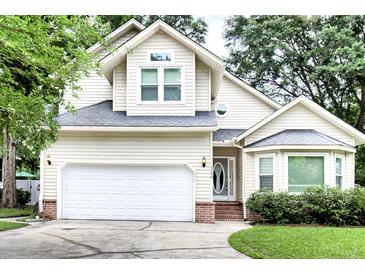 Charming two-story home featuring a two-car garage, a well-manicured lawn, and classic suburban curb appeal at 5359 Curtisston Ct, North Charleston, SC 29418