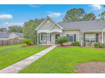 Charming single-story home features a cozy front porch and well-manicured lawn at 7300 Suncatcher Dr, Hanahan, SC 29410