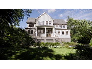 Charming two-story home featuring a welcoming front porch, landscaped yard, and classic architectural details at 117 Spartina Ct, Kiawah Island, SC 29455