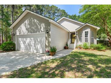Charming single-Gathering home with attached garage and a well-maintained front yard at 1227 Ocean View Rd, Charleston, SC 29412