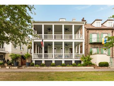 Stunning two-story home features a spacious double porch, complete with columns and ceiling fans at 18 Fernandina St, Mount Pleasant, SC 29464