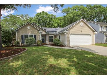 Charming single-Gathering home with a manicured lawn, mature trees, and an attached garage at 1939 Oak Tree Ln, Mount Pleasant, SC 29464
