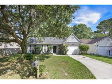 Charming single-story home featuring a well-manicured lawn and mature landscaping at 2418 Castlereagh Rd, Charleston, SC 29414