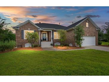 Charming brick home with manicured lawn, and a driveway leading to the attached garage in a well-lit setting at 2772 Latrobe Ct, Mount Pleasant, SC 29466