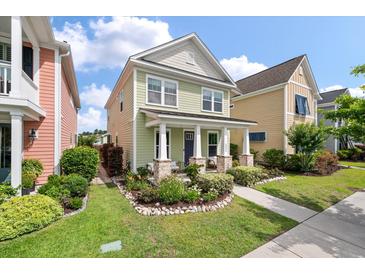 Charming two-story home with inviting front porch and landscaped yard, enhancing curb appeal at 3046 Sweetleaf Ln, Johns Island, SC 29455