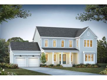 Charming two-story home with a welcoming front porch and attached two-car garage at 409 Wood Lilly Loop, Summerville, SC 29486