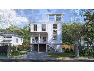 Beautiful three-story home with a charming staircase and a well-manicured lawn at 814 Palm Blvd, Isle of Palms, SC 29451