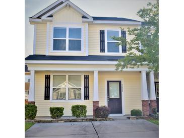 Charming two-story home featuring a welcoming front porch and well-maintained landscaping at 9088 Parlor Dr, Ladson, SC 29456