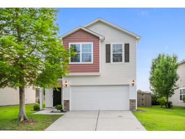 Charming two-story home with white siding, brick accents, and an attached two car garage at 9747 Seed St, Ladson, SC 29456