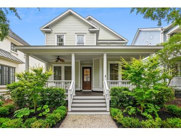 Charming two-story home featuring a welcoming front porch with elegant columns and beautifully landscaped yard at 1474 Blue Cascade Dr, Mount Pleasant, SC 29464