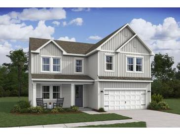 Charming two-story home featuring a classic architectural style and a well-manicured front lawn at 2042 Mcguire Ln # 011, Hollywood, SC 29449