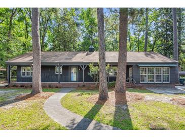 Charming single story home with brick foundation, porch, and mature trees at 205 Woodlawn St, Walterboro, SC 29488