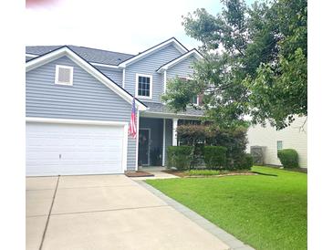 Charming two-story home with gray siding, white trim, a well-manicured lawn, and an attached two-car garage at 216 Goldfinch Ln, Summerville, SC 29485