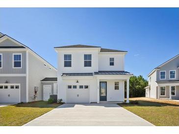 Charming two-story home featuring a single-car garage, a welcoming front porch, and a well-manicured front yard at 350 Chapman Cir, Goose Creek, SC 29445