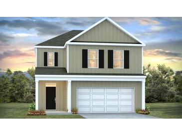 Charming two-story home with a white garage door, complemented by a well-maintained lawn and appealing curb appeal at 413 Mistflower Ln, Moncks Corner, SC 29461