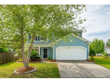 Charming two-story home with a well-manicured lawn, attached garage, and beautiful landscaping at 489 Dolphin Dr, Summerville, SC 29485