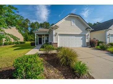 Charming one-story home with a two-car garage, well-manicured lawn and shrubbery at 626 Battery Edge Dr, Summerville, SC 29486