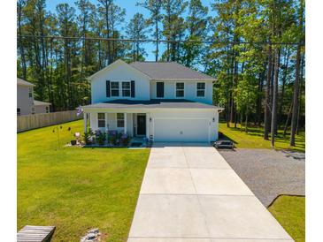 Two story home with a large yard, two car garage, and beautiful landscaping at 689 W Butternut Rd, Summerville, SC 29483