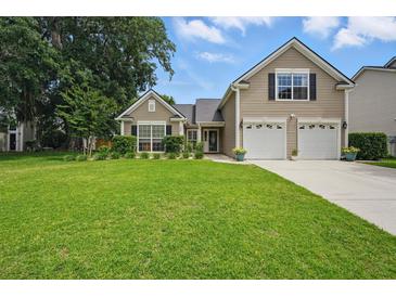 Charming two-story home with a well-manicured lawn and a two car garage at 105 Corral Cir, Summerville, SC 29485