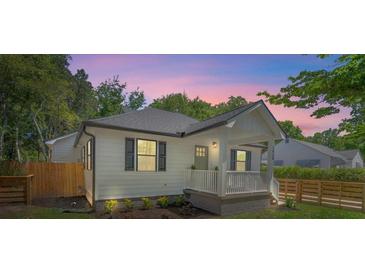 Charming bungalow home features a cozy front porch, modern design, and a well-maintained landscaped yard at 1430 E Montague Ave, North Charleston, SC 29405