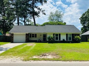 Charming one-story home with a well-maintained lawn and mature trees at 214 Four Iron Dr, Summerville, SC 29483