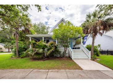 Charming two-story home with a front porch, lush landscaping, and a welcoming entrance at 2613 Rivertowne Pkwy, Mount Pleasant, SC 29466