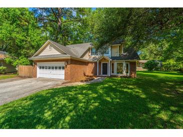 Charming two-story brick home with a well-manicured lawn and attached two car garage at 2650 Summer Leaves Ct, Charleston, SC 29414