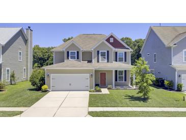 Charming two-story home with a well-manicured lawn, two-car garage, and inviting red front door at 308 Legendres Dr, Goose Creek, SC 29445