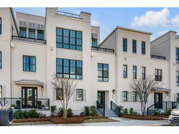Beautifully designed multi-story townhouse with large windows and manicured landscaping at 405 Spartina Ln # 405, Charleston, SC 29492