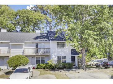 Charming two-story townhouse with a balcony, well-maintained landscaping, and ample parking at 4662 Nibbs Ln, North Charleston, SC 29418