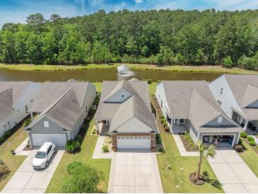 An aerial view of the house, showing the lake and fountain behind the house at 548 Sea Foam St, Summerville, SC 29486