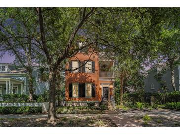 Charming two-story home with wood siding, a covered balcony, and lush landscaping at 82 Ponsbury Rd, Mount Pleasant, SC 29464