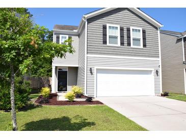 Charming two-story home featuring gray siding, black shutters, a two-car garage, and well-maintained landscaping at 9694 Roseberry St, Ladson, SC 29456